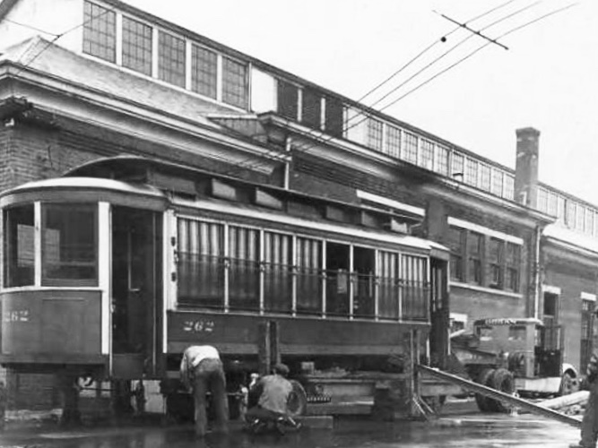 Historic maintenance photo of a streetcar outside the car barn