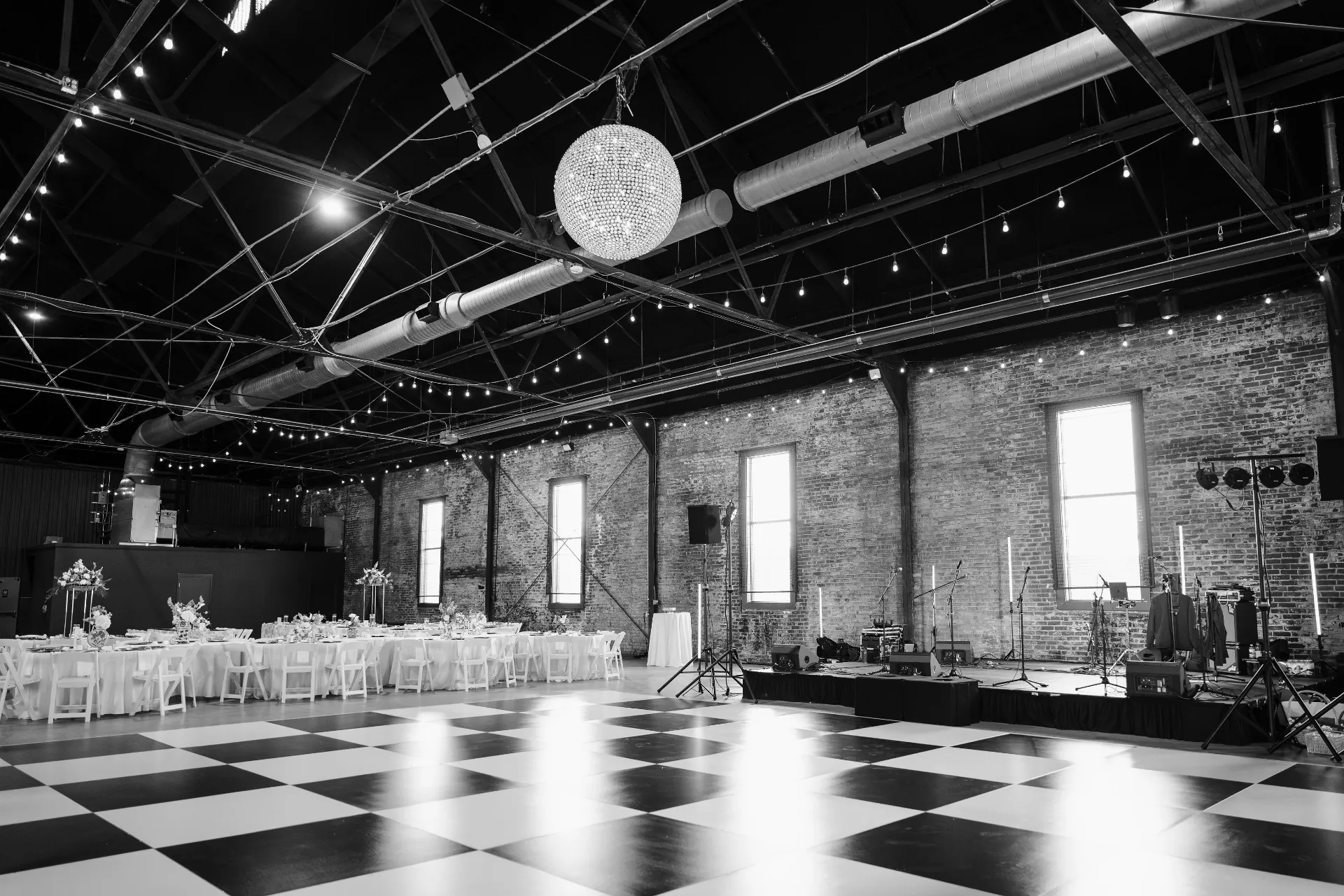 Black and white checkered dance floor beneath the beaded chandelier