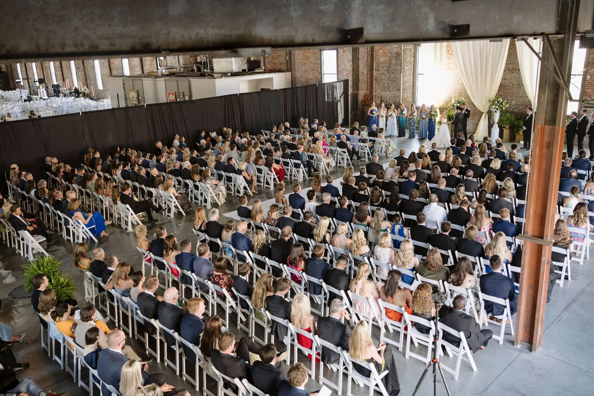 Wedding ceremony seen from above showing the full seated crowd