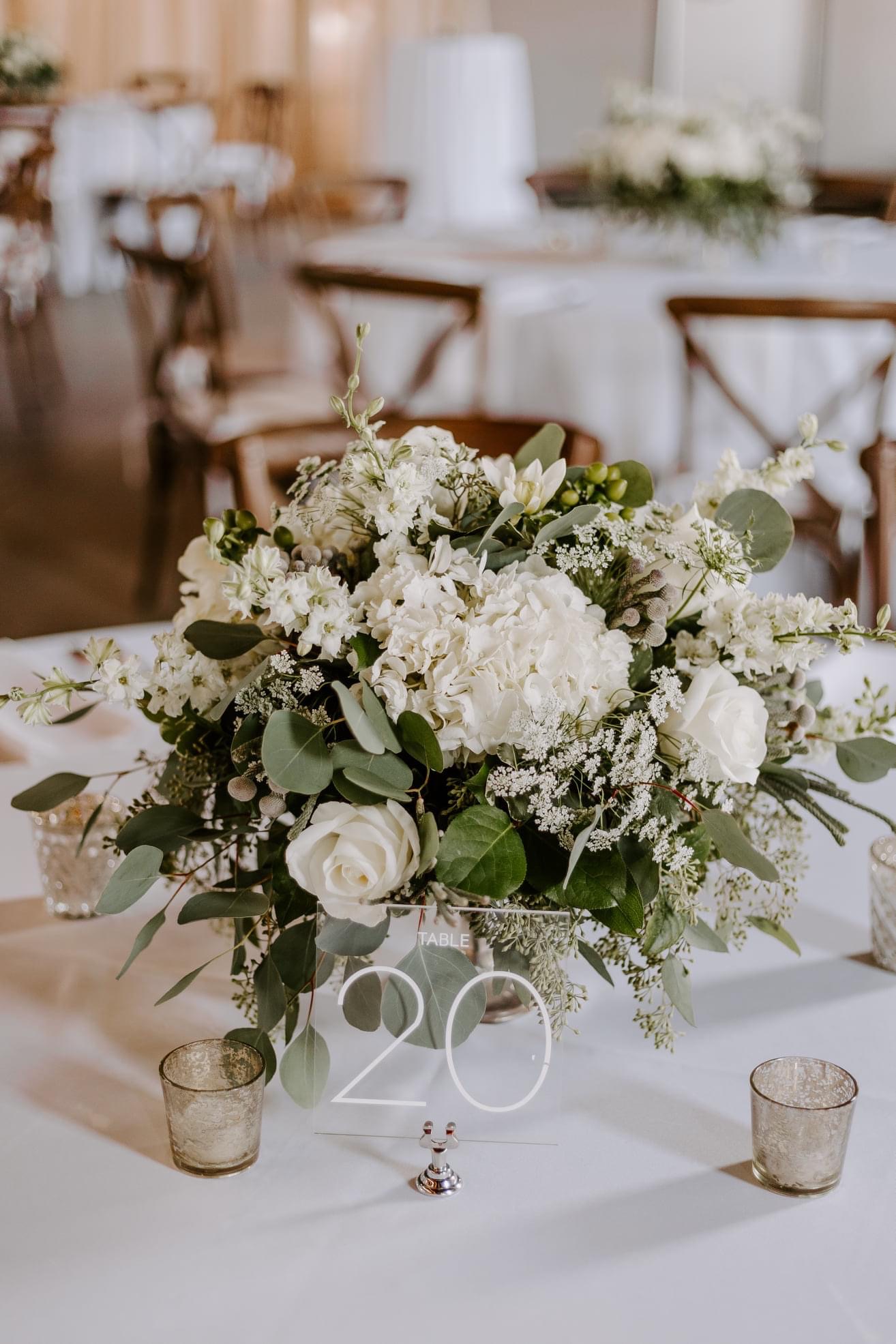 White floral centerpiece on a reception table