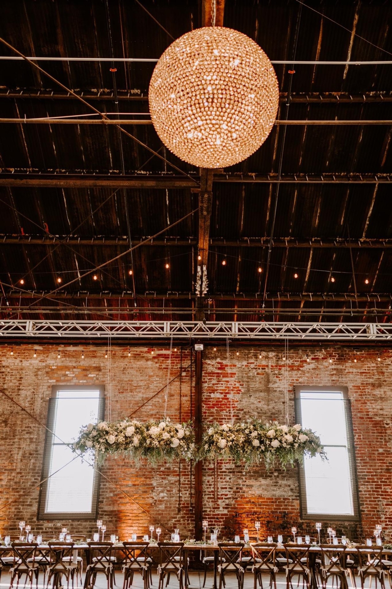 Beaded chandelier above the brick wall